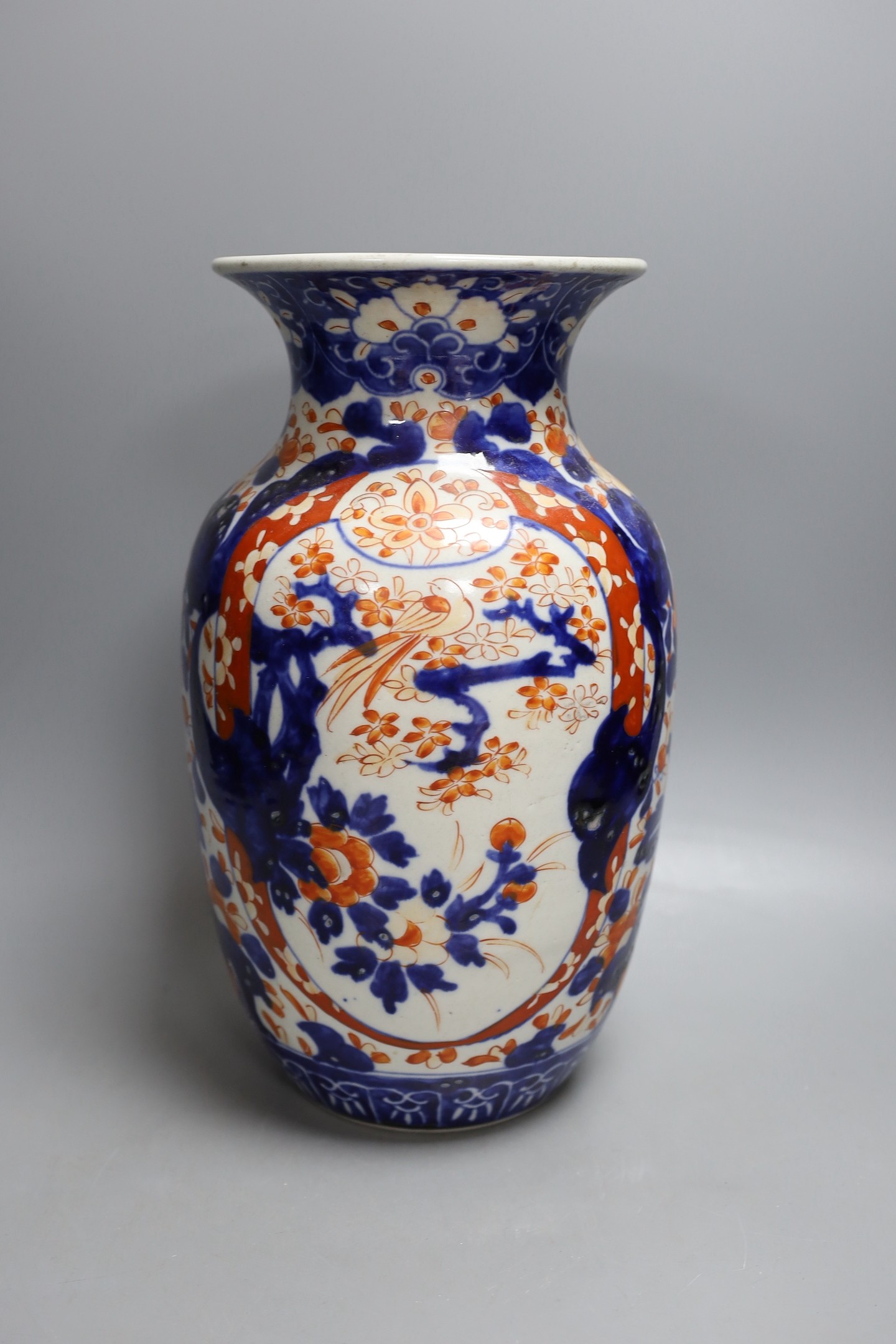 Four Japanese Imari dishes and a vase, vase 31 cms high. (5)